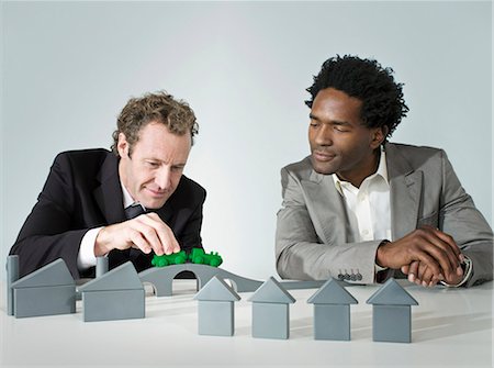 Two business men play with a train Stock Photo - Premium Royalty-Free, Code: 649-03154012