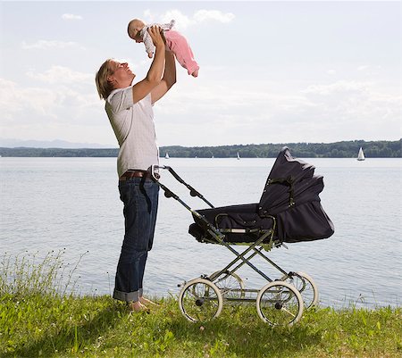 dad lifting baby from pram Stock Photo - Premium Royalty-Free, Code: 649-03154041