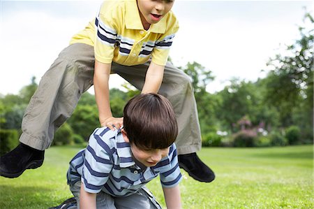 Kids playing in garden Stock Photo - Premium Royalty-Free, Code: 649-03154904