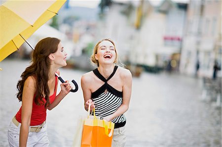 plaza - girls having fun in the rain Stock Photo - Premium Royalty-Free, Code: 649-03153588