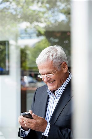 Senior Businessman Using Cellphone Stock Photo - Premium Royalty-Free, Code: 649-03153674