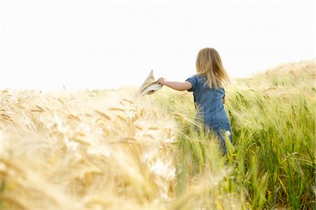 Girl running in a wheat field Stock Photo - Premium Royalty-Free, Code: 649-03296284