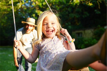 pushing - Father pushing his girl on the swing Stock Photo - Premium Royalty-Free, Code: 649-03296404