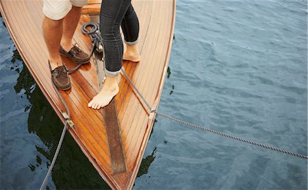 Feet of middle aged couple on old boat Stock Photo - Premium Royalty-Free, Code: 649-03296470