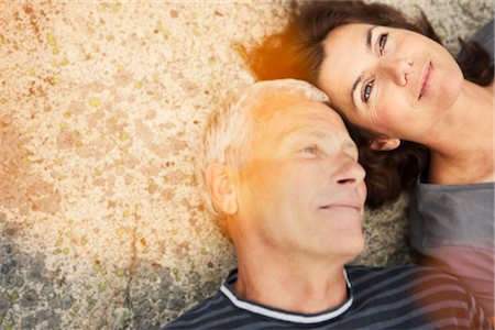 Middle aged couple on rocks with flare Stock Photo - Premium Royalty-Free, Code: 649-03296506