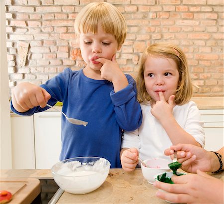 girl, boy tasting baking ingredients Stock Photo - Premium Royalty-Free, Code: 649-03296628