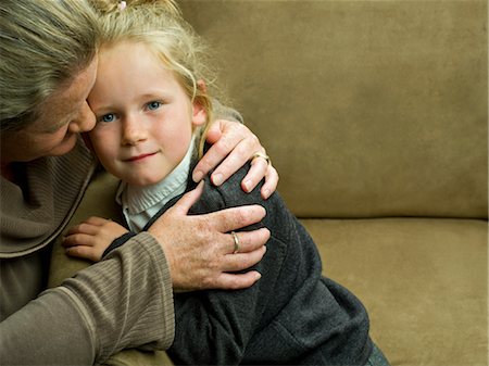 simsearch:614-06043612,k - A young girl being hugged by her mum Stock Photo - Premium Royalty-Free, Code: 649-03297373