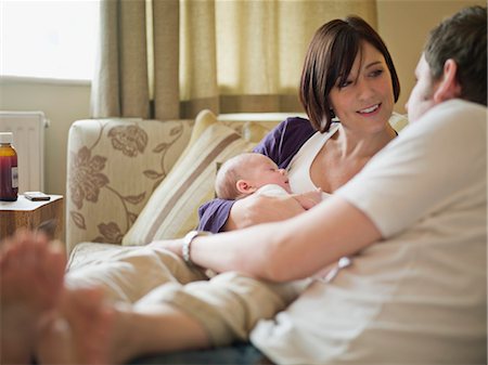 simsearch:400-05119279,k - A couple and new baby sitting on a sofa Stock Photo - Premium Royalty-Free, Code: 649-03297401