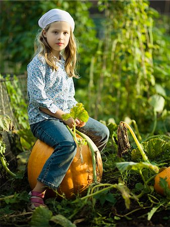 simsearch:649-03775589,k - Young girl sitting on a pumpkin Stock Photo - Premium Royalty-Free, Code: 649-03297430