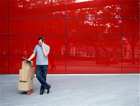 red call box - A courier delivers parcels Stock Photo - Premium Royalty-Free, Code: 649-03297666