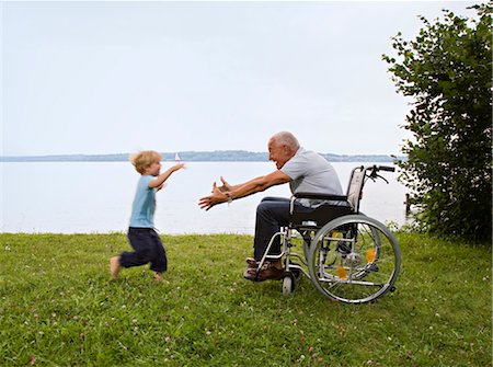 disable - boy running into arms of senior man Stock Photo - Premium Royalty-Free, Code: 649-03292719