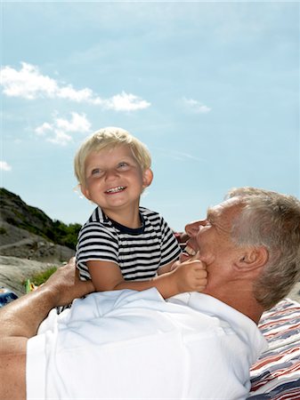 Grandfather and boy hugging Stock Photo - Premium Royalty-Free, Code: 649-03292896