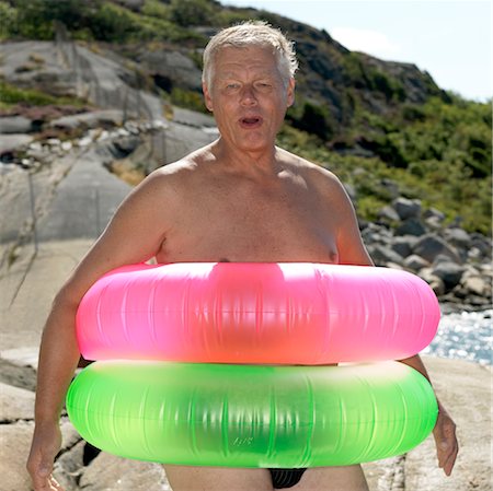 senior humour - Senior man with two inflatable rings Stock Photo - Premium Royalty-Free, Code: 649-03292907