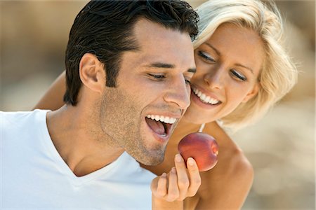 A female feeding a latin man an apple. Stock Photo - Premium Royalty-Free, Code: 649-03292925