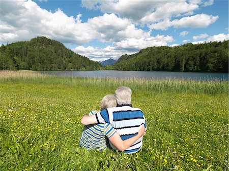 Senior couple sitting in field by lake Stock Photo - Premium Royalty-Free, Code: 649-03292963