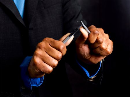 frustrated black business man - Business man breaking pencil in half Stock Photo - Premium Royalty-Free, Code: 649-03293582