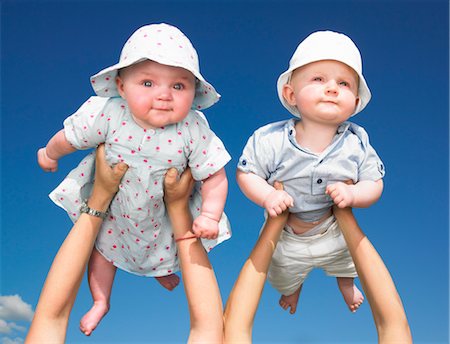 friends lifting someone - babies up in the air Stock Photo - Premium Royalty-Free, Code: 649-03293712