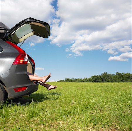 feet hanging out of car trunk Stock Photo - Premium Royalty-Free, Code: 649-03293769