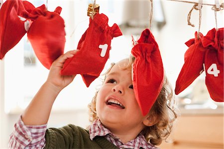 special occasion - Young boy inspecting christmas sacks Stock Photo - Premium Royalty-Free, Code: 649-03362626