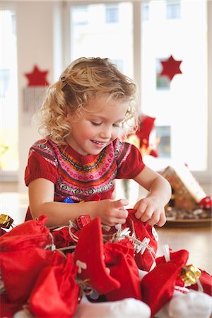 young girl playing with gift sacks Stock Photo - Premium Royalty-Free, Code: 649-03362653