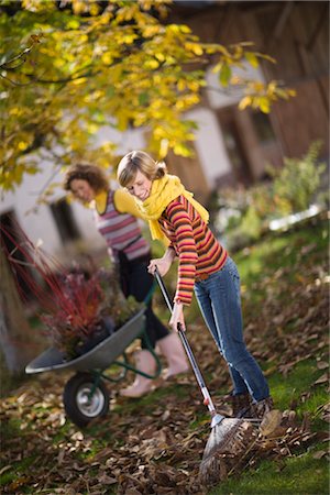 fall leaves teenagers - autumnal gardening Stock Photo - Premium Royalty-Free, Code: 649-03417391