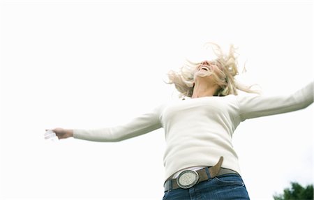 Woman jumping with joy Stock Photo - Premium Royalty-Free, Code: 649-03417631