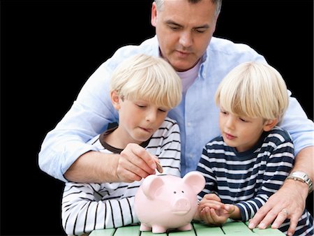 families wealthy - Father teaching sons to save Stock Photo - Premium Royalty-Free, Code: 649-03417640