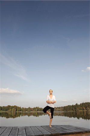 Young woman doing yoga exercise Stock Photo - Premium Royalty-Free, Code: 649-03447339