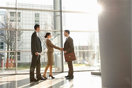 Businesswoman shaking hands with man Stock Photo - Premium Royalty-Free, Code: 649-03447382