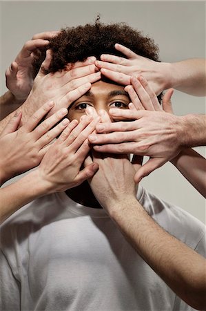 Black male hidden by hands Stock Photo - Premium Royalty-Free, Code: 649-03447554