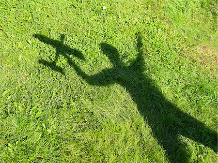 shadow plane - Shadow of a woman holding an rc plane Stock Photo - Premium Royalty-Free, Code: 649-03447606