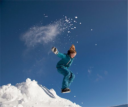 Girl jumping in snow Stock Photo - Premium Royalty-Free, Code: 649-03447851