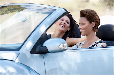 friends driving - Two women laughing in a convertible car Stock Photo - Premium Royalty-Free, Code: 649-03447898