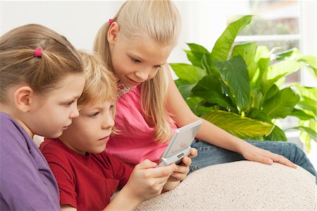 simsearch:632-03424261,k - Children playing a game on a console Stock Photo - Premium Royalty-Free, Code: 649-03447943