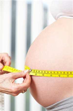 pregnant woman with doctor - Hands measuring pregnant belly Stock Photo - Premium Royalty-Free, Code: 649-03448381