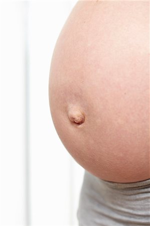 pregnant belly button - A pregnant belly Stock Photo - Premium Royalty-Free, Code: 649-03448382