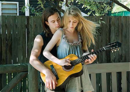 simsearch:614-06719795,k - Girl playing guitar with young man Stock Photo - Premium Royalty-Free, Code: 649-03465625