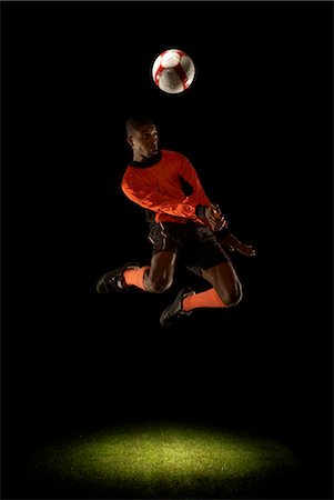 spotlight (beam of light) - Footballer jumping for header Stock Photo - Premium Royalty-Free, Code: 649-03466205