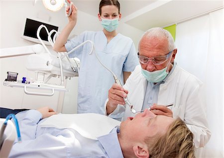 Dentist with patient in surgery Stock Photo - Premium Royalty-Free, Code: 649-03487235