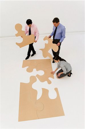 puzzle piece - 3 business people complete the puzzle Stock Photo - Premium Royalty-Free, Code: 649-03487791