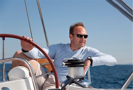 Man steering yacht Stock Photo - Premium Royalty-Free, Code: 649-03510989