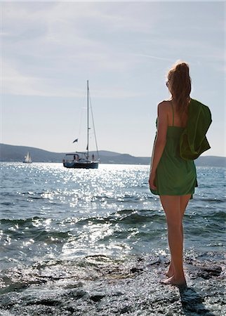 seeing - Woman at beach looking at yacht Stock Photo - Premium Royalty-Free, Code: 649-03510994