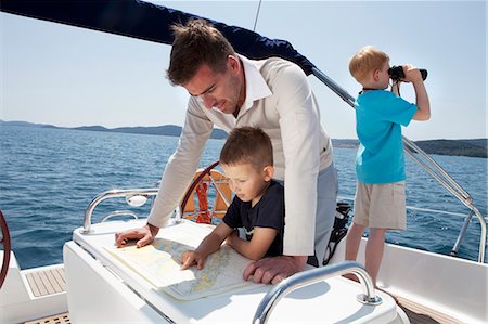 simsearch:630-06724175,k - Father and sons on yacht Stock Photo - Premium Royalty-Free, Code: 649-03511009