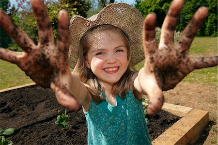 dirty - Young girl in garden with muddy hands Stock Photo - Premium Royalty-Free, Code: 649-03565881