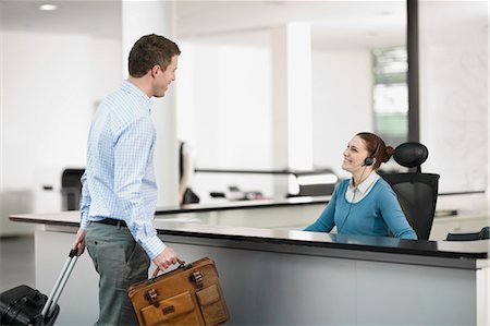 roll on luggage - Man at a reception Stock Photo - Premium Royalty-Free, Code: 649-03565953