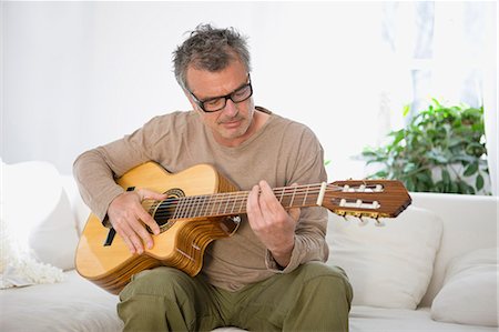 simsearch:614-06719795,k - Man strumming guitar Stock Photo - Premium Royalty-Free, Code: 649-03566005