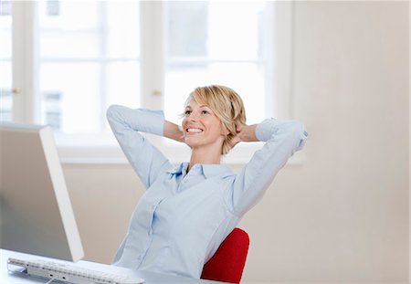 relaxation in the office - Young woman relaxing at desk Stock Photo - Premium Royalty-Free, Code: 649-03566467