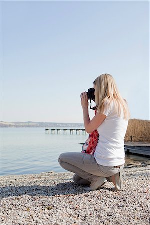 Woman taking pictures at a sea Stock Photo - Premium Royalty-Free, Code: 649-03566950