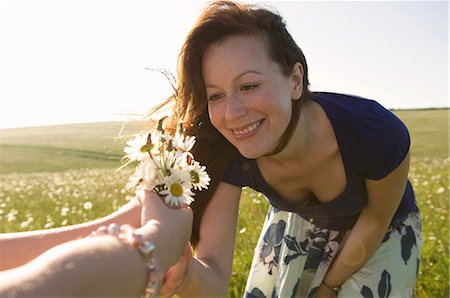 daisy flower - Happy woman looks at wild flowers Stock Photo - Premium Royalty-Free, Code: 649-03566999