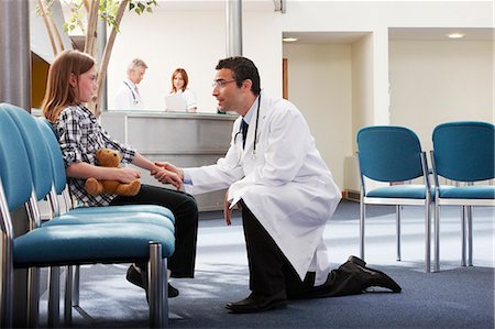 Doctor greeting young girl in surgery Stock Photo - Premium Royalty-Free, Code: 649-03621611